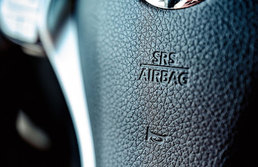 Interior view showing an airbag sign in the center of the steering wheel.
